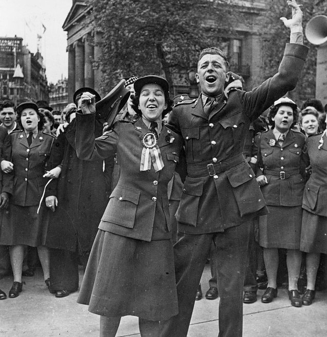 An old black and white photograph of British soldiers celebrating VE Day
